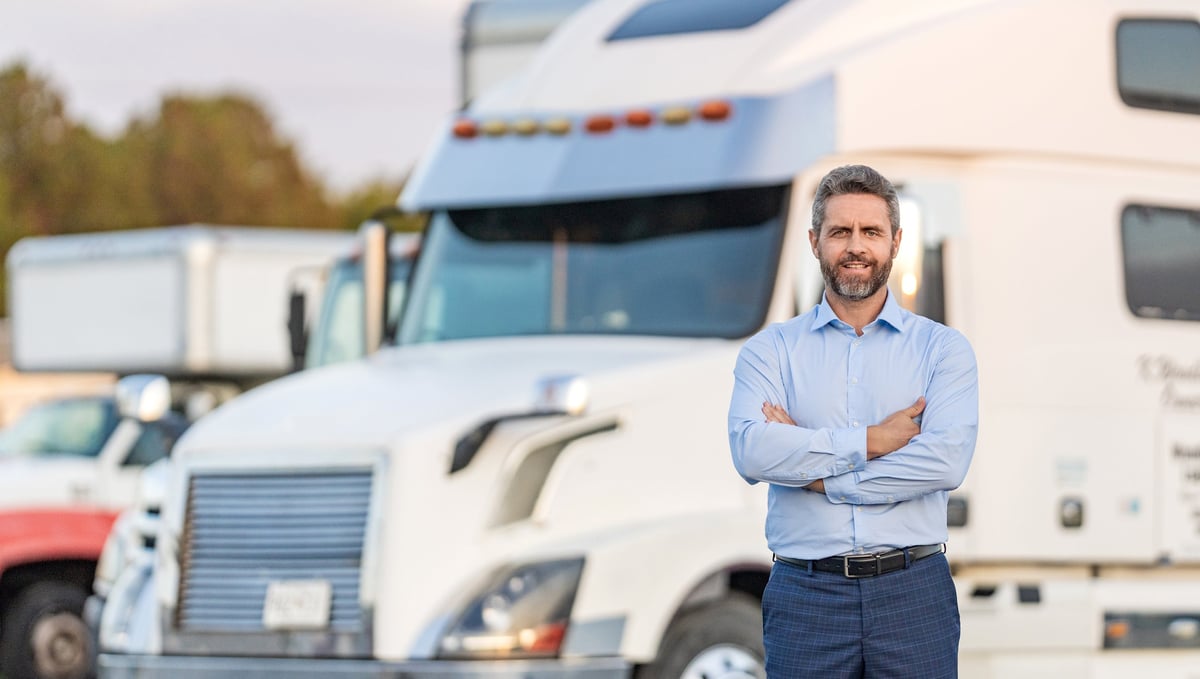 Truck owner standing in front of his semi-truck
